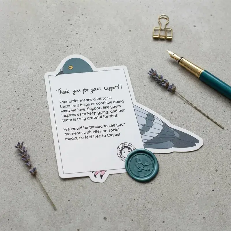Pigeon-shaped card beside stationery and a round wax seal.