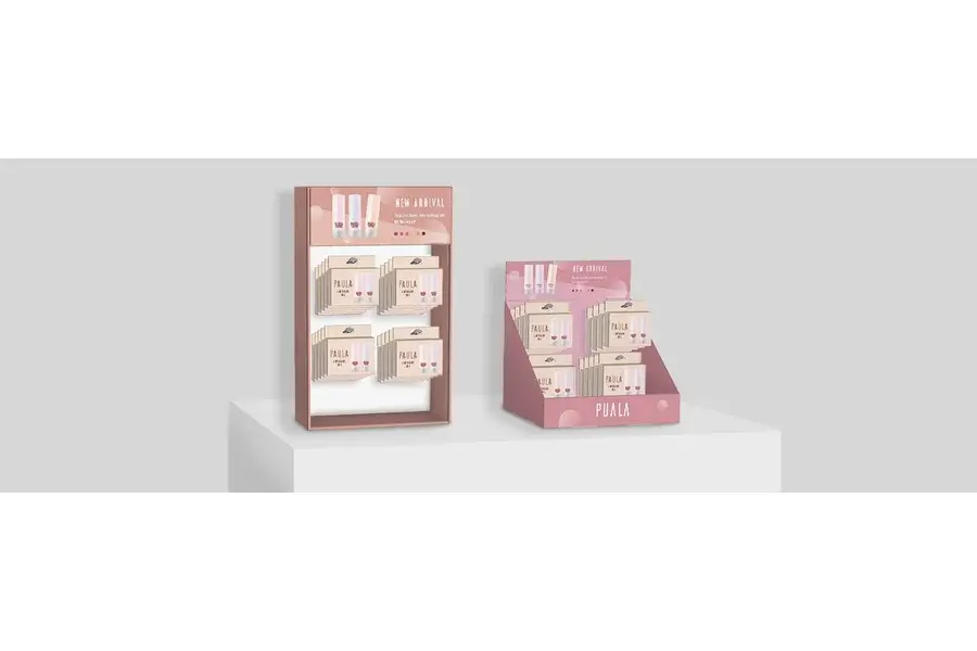 Pink countertop displays holding rows of small printed cards.