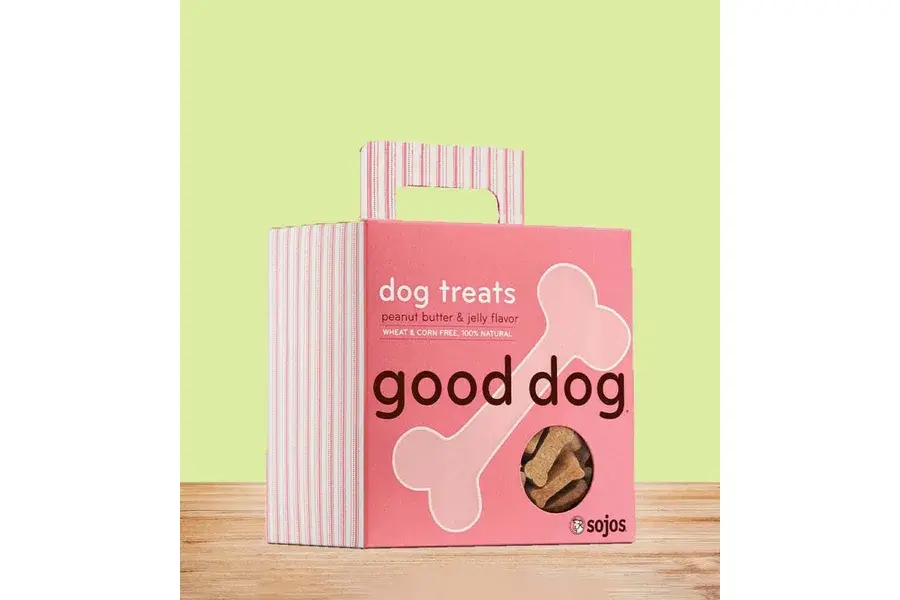 Pink dog treat box with a bone-shaped window and striped top.