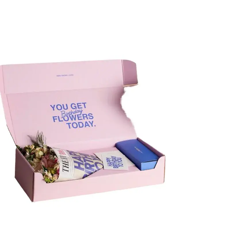 Open pink gift mailer containing printed items and a small blue box.
