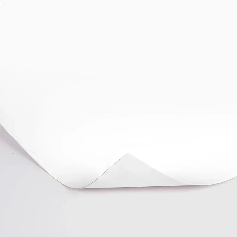 Plain white paper sheet with one corner gently curled upward.