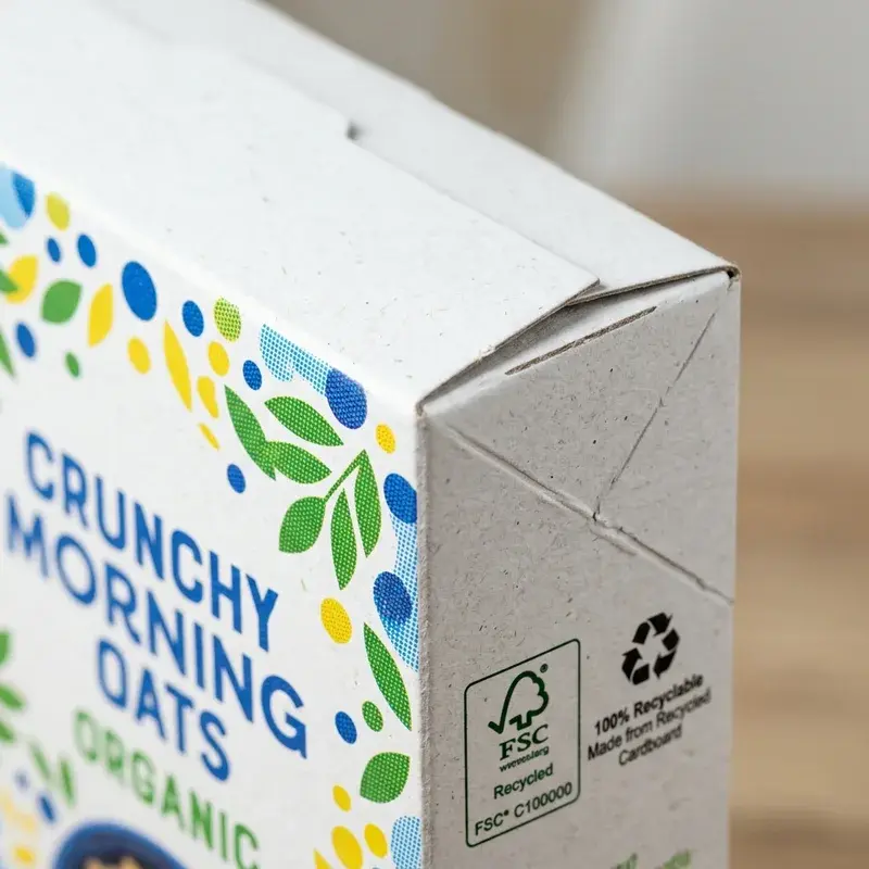 Close view of a printed carton corner and folded top seam.
