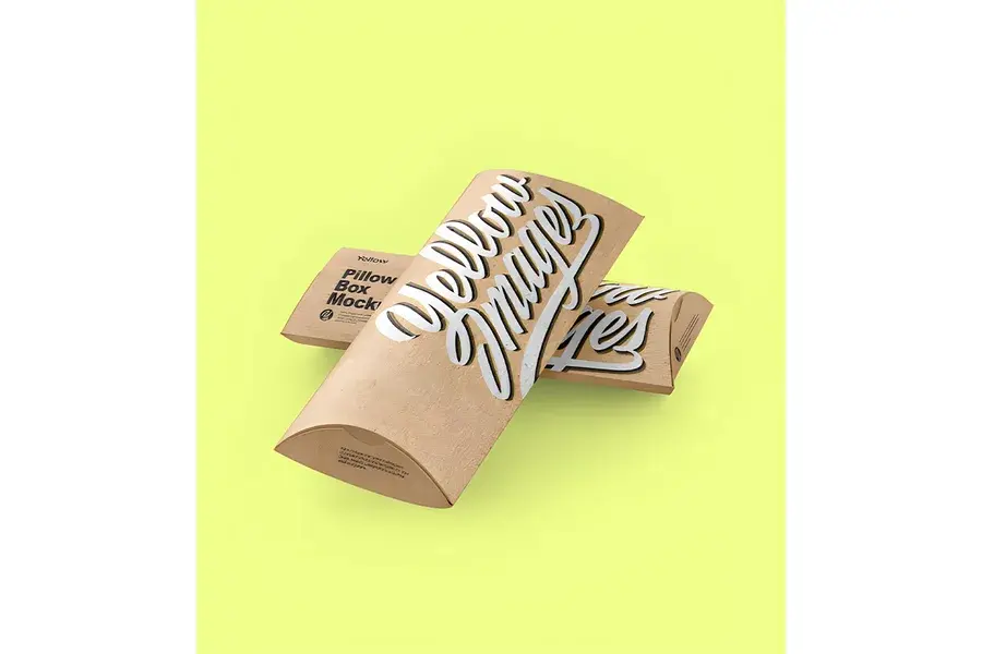 Kraft pillow boxes with dark printing on a bright yellow background.