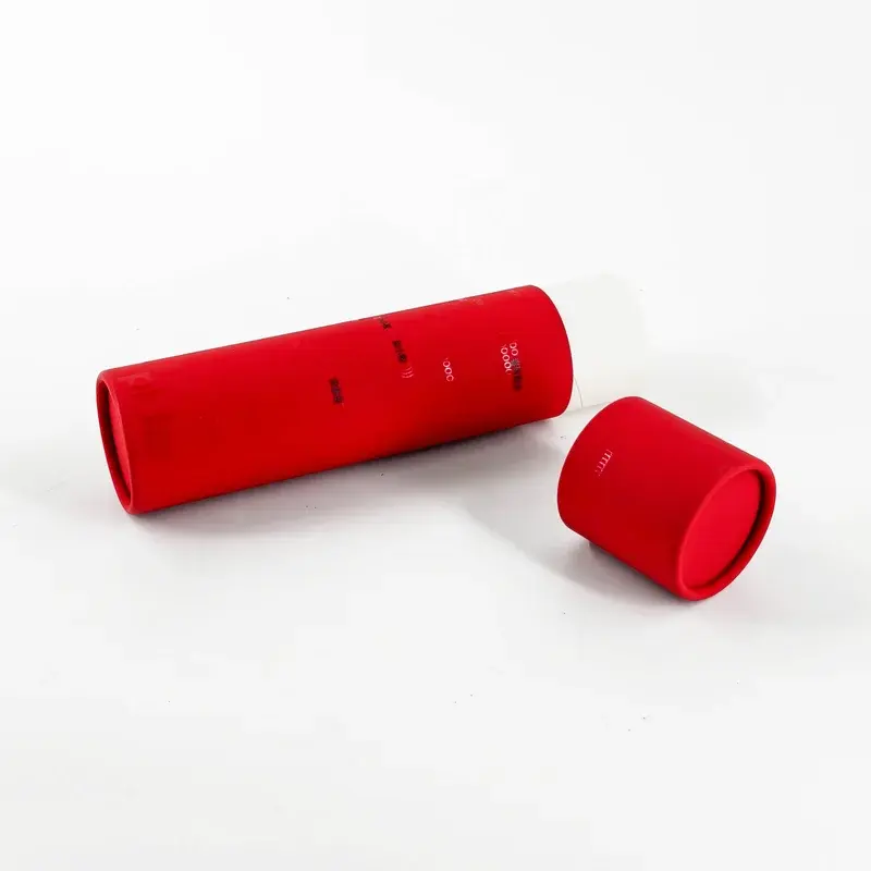 Long red paper tube beside its detached round cap.