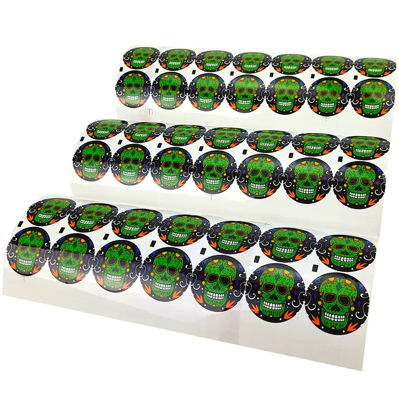 Sheets of round green and black printed stickers.