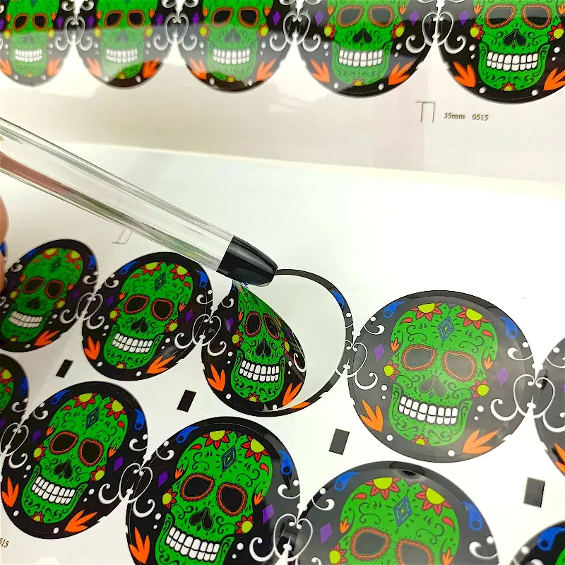 Close view of round green stickers and a lifted sticker edge.