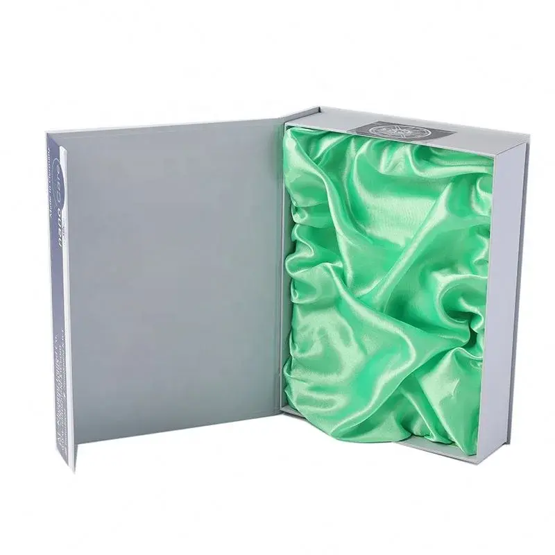 Open silver-colored box with gathered green fabric lining.