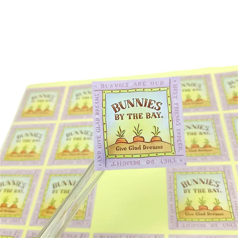One pastel square label positioned above a matching label sheet.