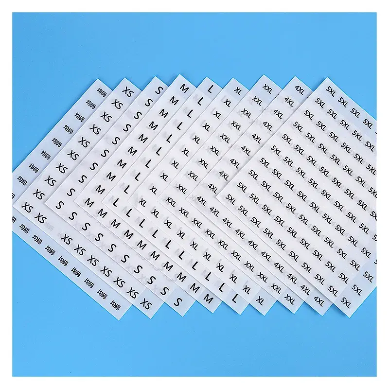 Overlapping white sheets with rows of small black printed labels.
