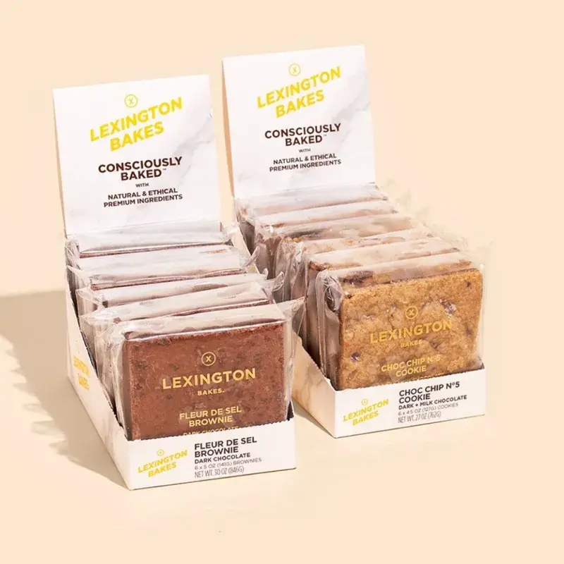 Two pale countertop displays holding individually wrapped snacks.