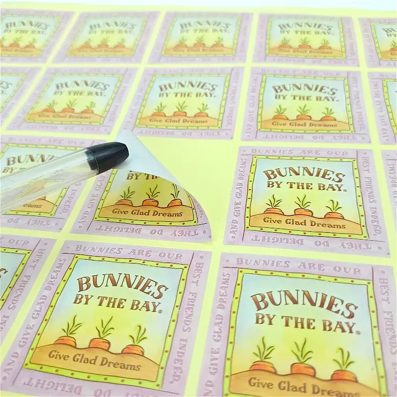 Close view of a square label being peeled from its backing.
