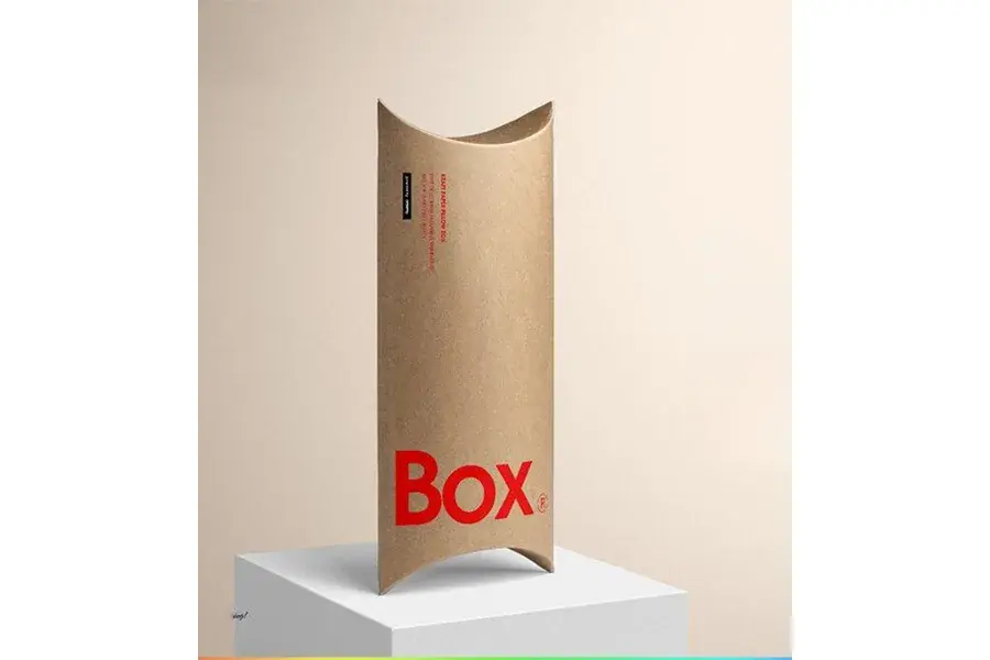 Tall kraft pillow box with red lettering near its base.