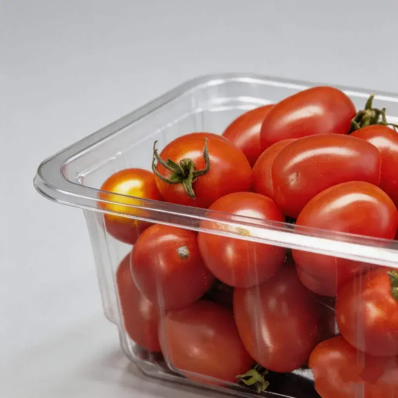 Close view of tomatoes and the rim of a clear container.