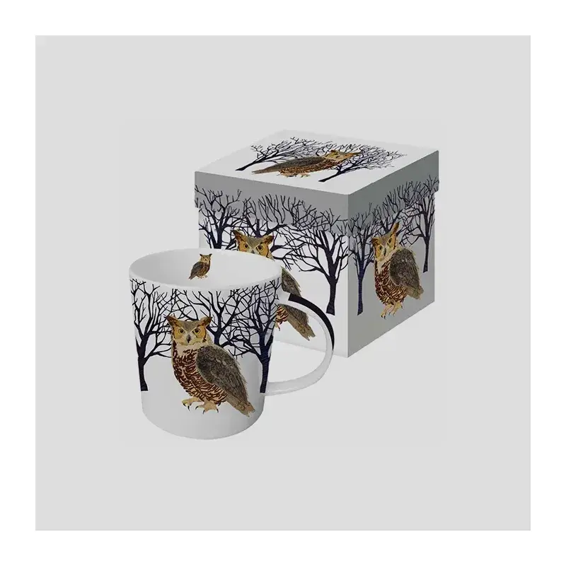 Tree-patterned mug beside a matching printed gift box.