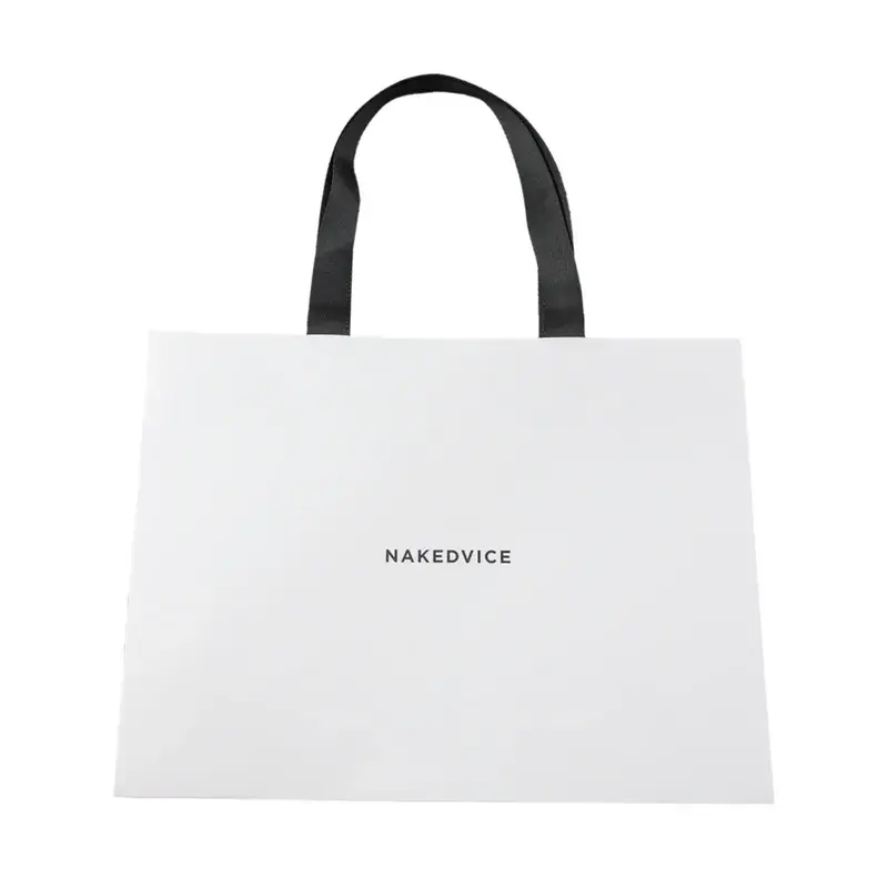White shopping bag with short black handles and small lettering.