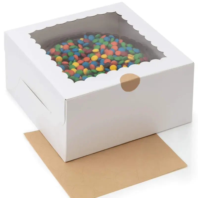 White cake box with a clear top window and a round front tab.