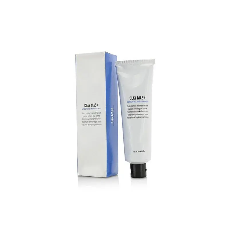 White cosmetic tube beside a tall blue-edged carton.