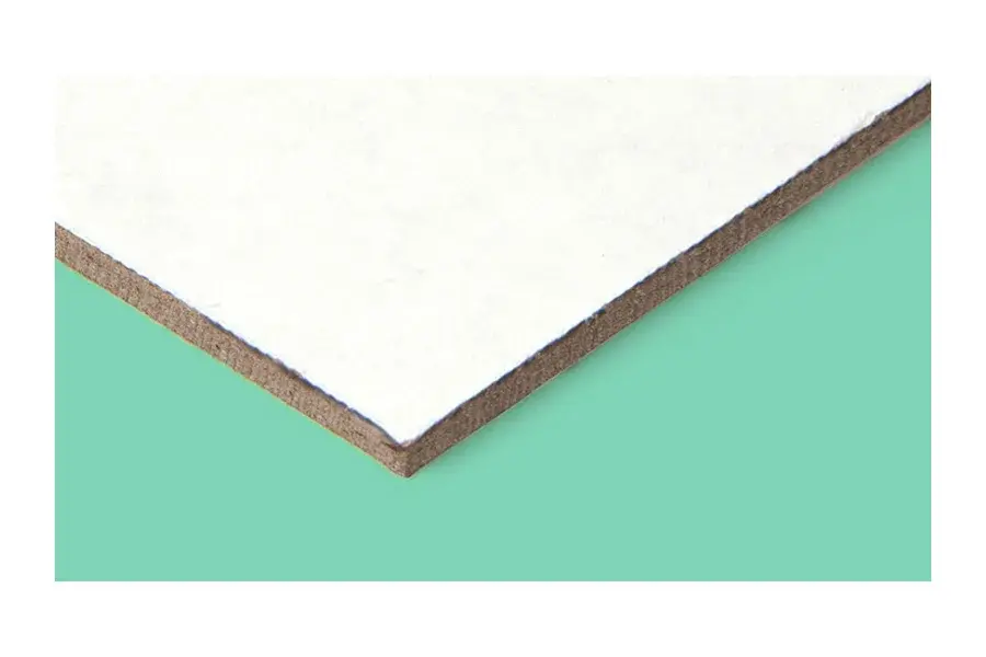 Close view of white-faced board with a visible brown edge.