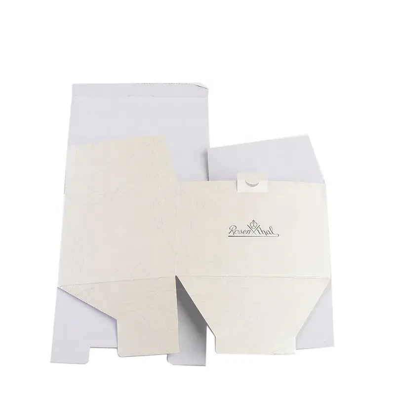 White carton blanks with printed lettering and unfolded flaps.