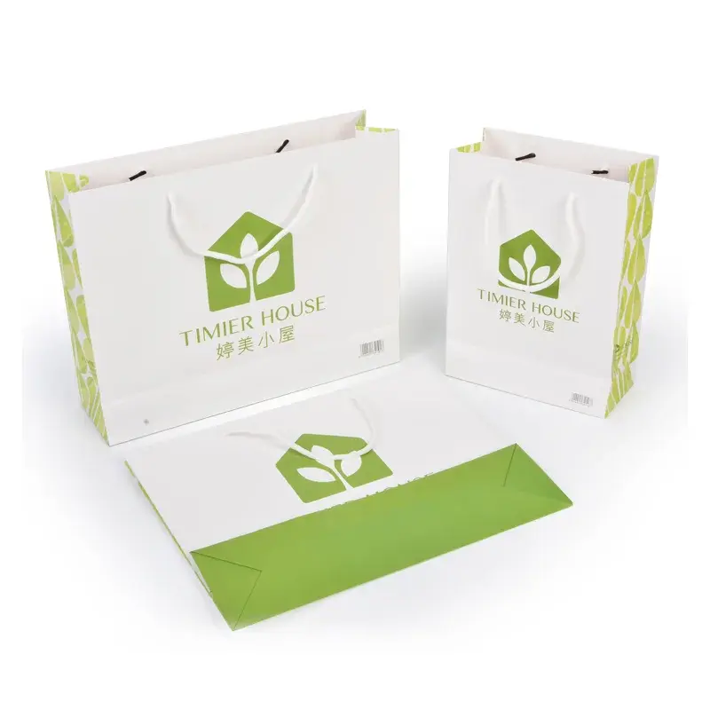 White shopping bags with green printed panels and cord handles.