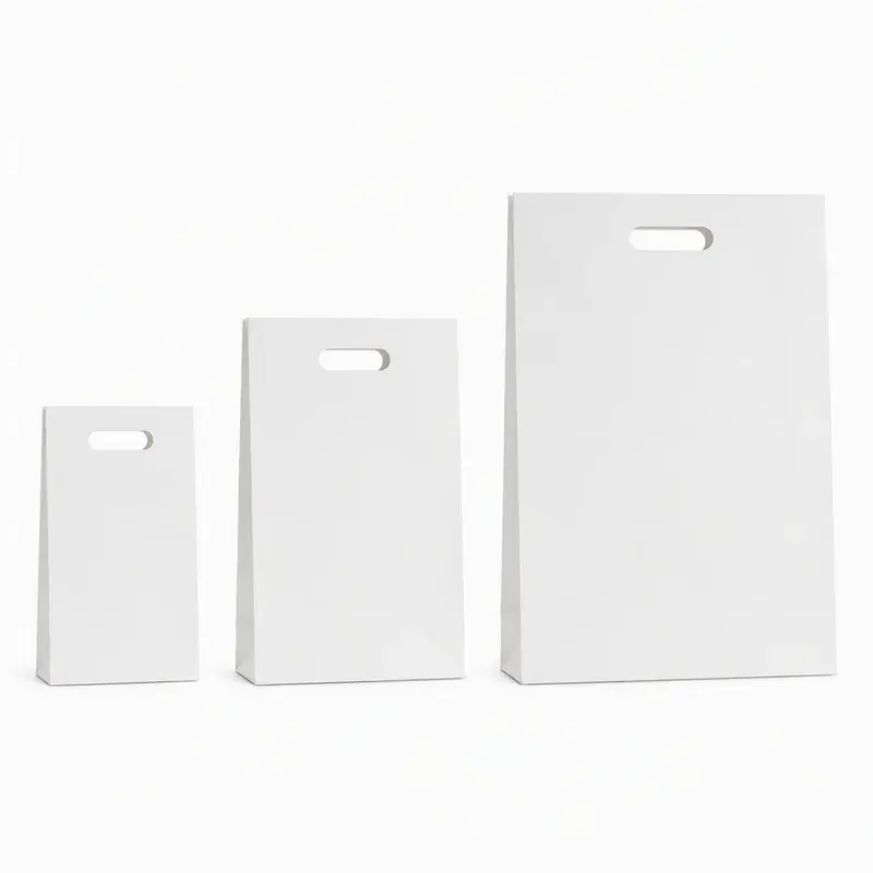 Three plain white bags in different sizes with cutout handles.