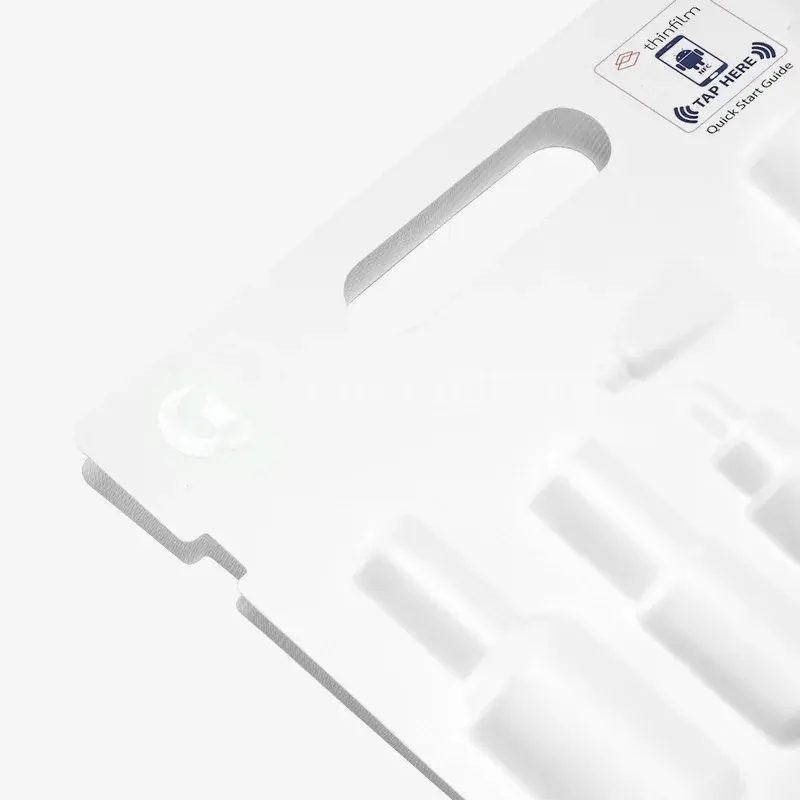 Close view of a white insert with molded channels and recesses.