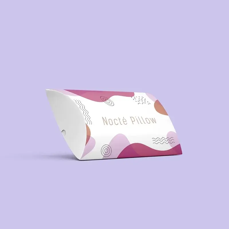 White pillow box with pink curved graphics and folded ends.