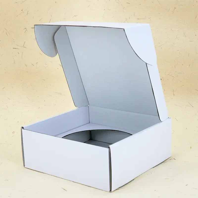 Angled view of a white box with a round insert opening.