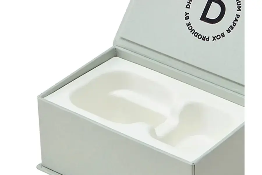Open pale green box with a white shaped insert.