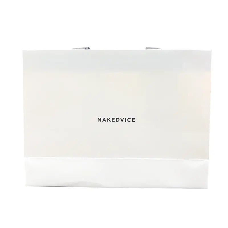 White shopping bag laid flat with small dark lettering.
