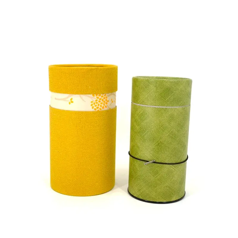 Yellow and green cylindrical containers with fitted lids.