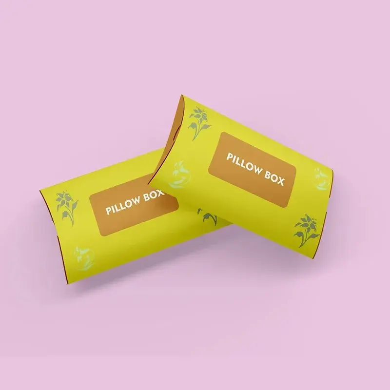 Two yellow pillow boxes with pale decorative printing.